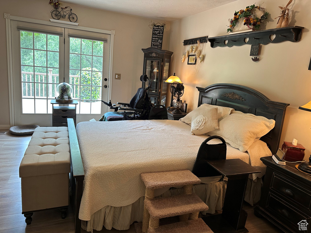Bedroom featuring access to outside and wood finished floors