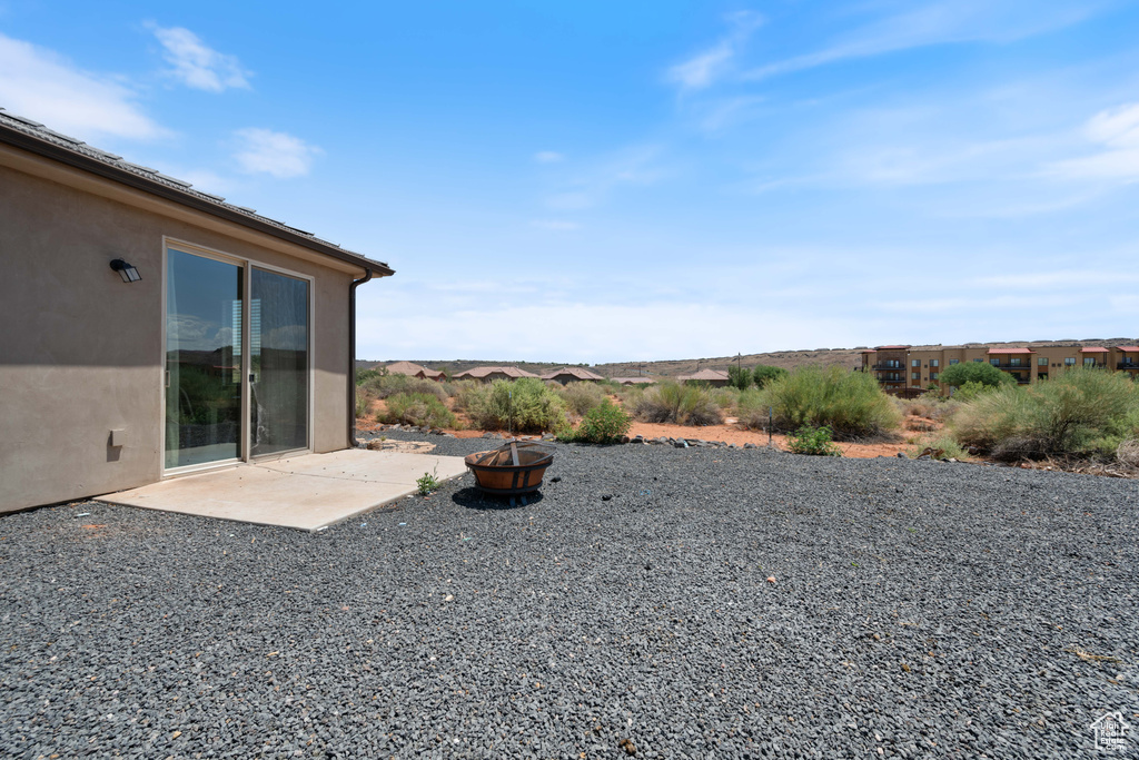 View of yard with a fire pit and a patio area