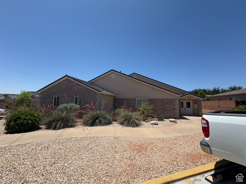 Ranch-style house with stucco siding and brick siding