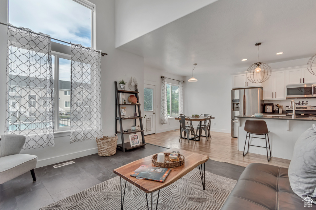Living area with recessed lighting, baseboards, and wood finished floors