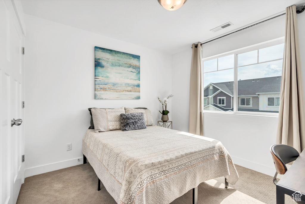 Carpeted bedroom with baseboards