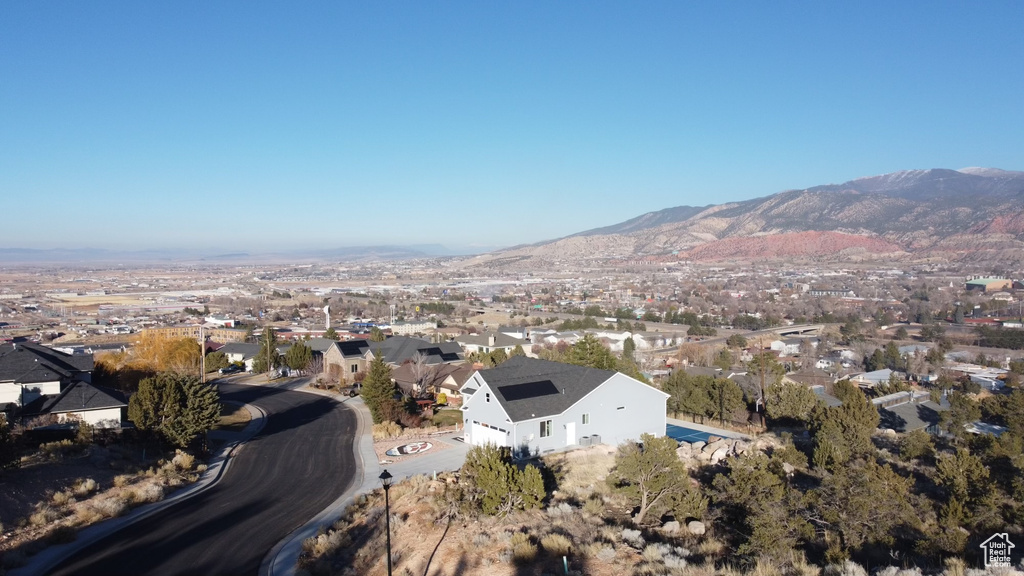 Aerial overview of property\'s location featuring a mountainous background and nearby suburban area