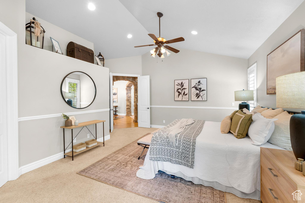 Bedroom featuring arched walkways, lofted ceiling, carpet flooring, recessed lighting, and a ceiling fan