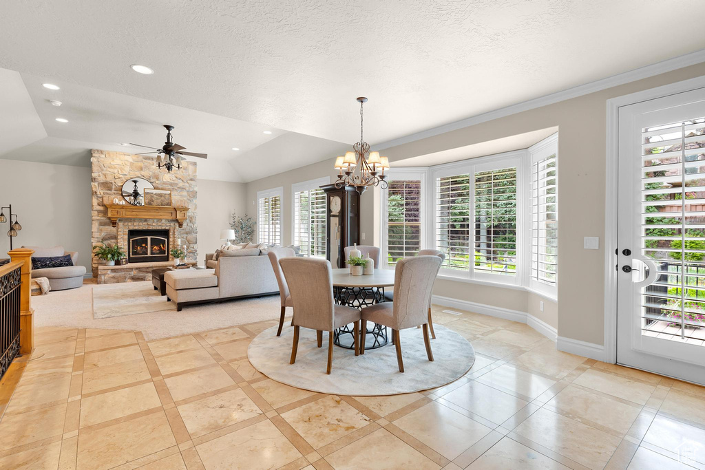 Dining room with ceiling fan, inlaid floor details, a chandelier, healthy amount of natural light, and recessed lighting