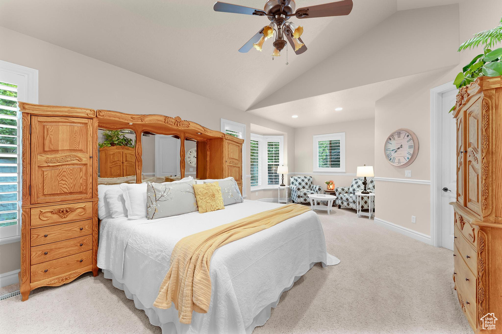 Bedroom with multiple windows, lofted ceiling, light carpet, baseboards, and recessed lighting