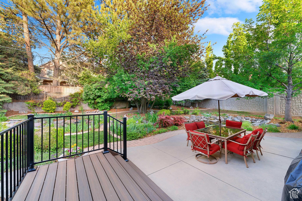 Deck with outdoor dining space and a patio