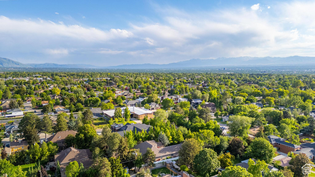 Aerial view of residential area featuring a mountainous background