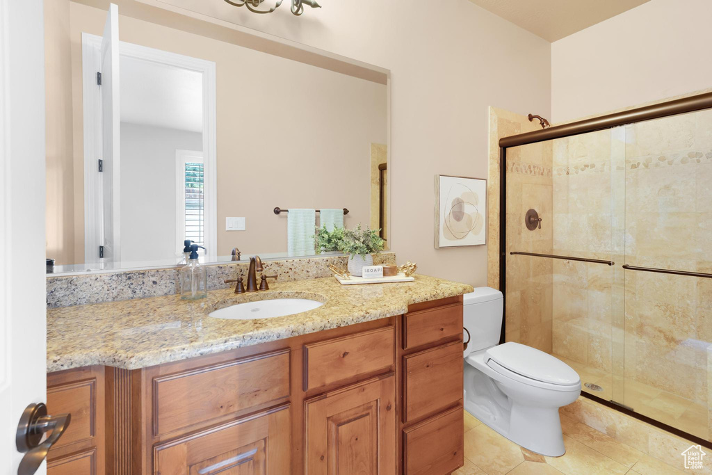 Full bath featuring a stall shower, vanity, and tile patterned floors