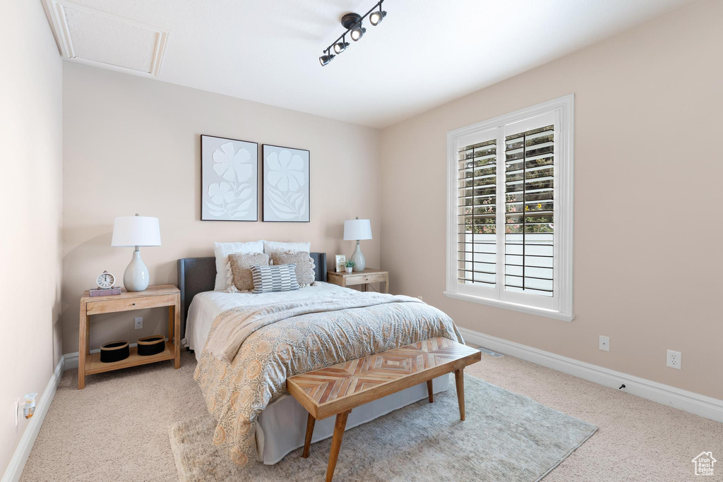 Bedroom featuring carpet floors and baseboards