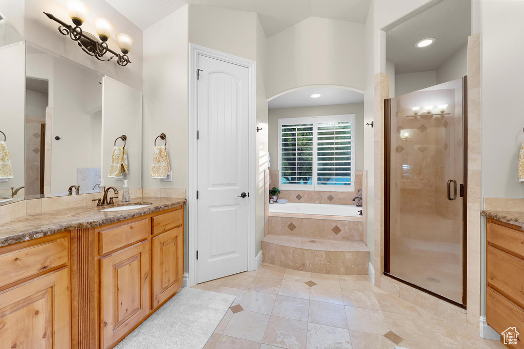 Full bathroom featuring vanity, a bath, a stall shower, and tile patterned floors