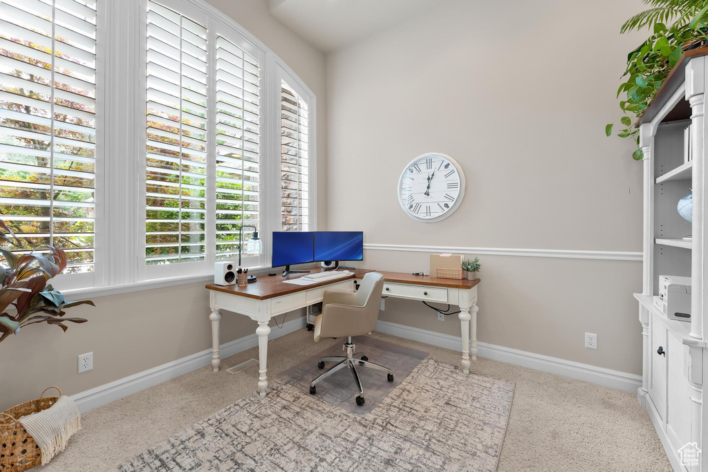 Office space with carpet floors and baseboards