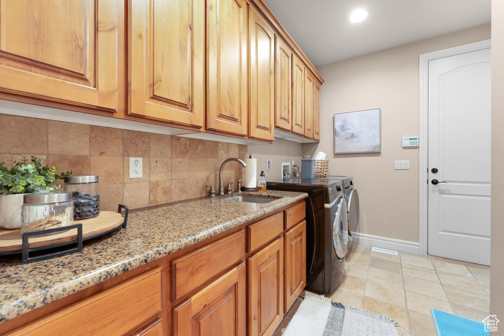 Laundry room with washer and clothes dryer, cabinet space, and recessed lighting