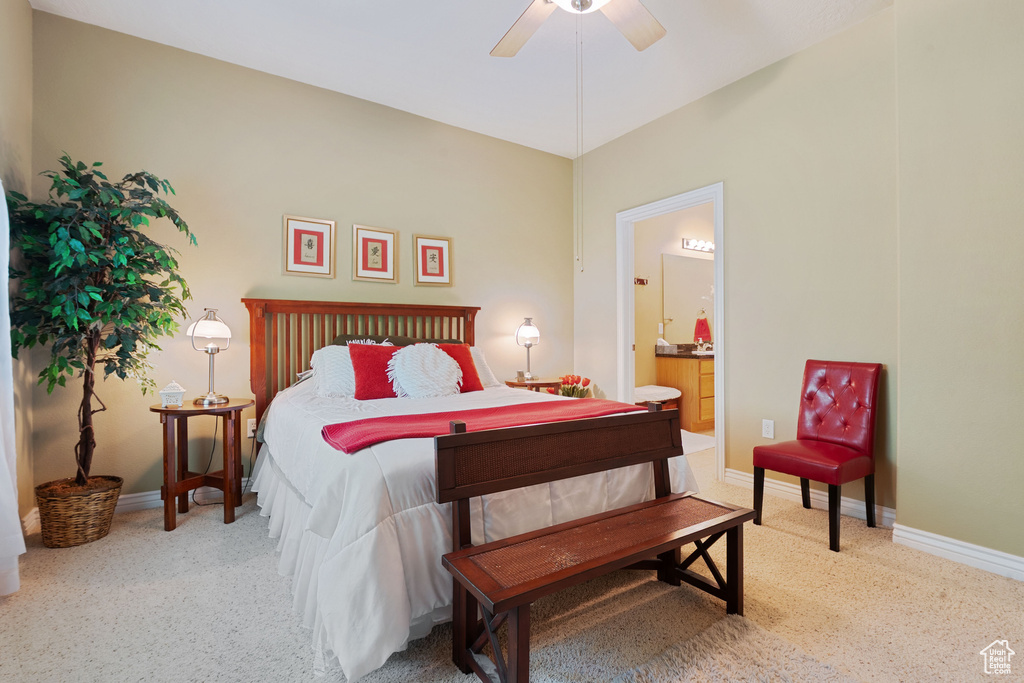 Bedroom with carpet flooring, baseboards, ensuite bath, and ceiling fan