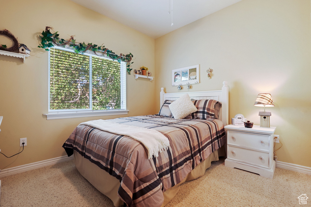 Bedroom featuring carpet and baseboards