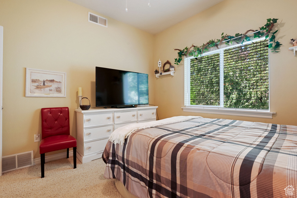 Bedroom featuring light colored carpet