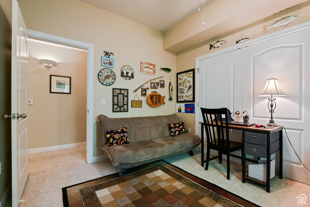 Home office with speckled floor and baseboards