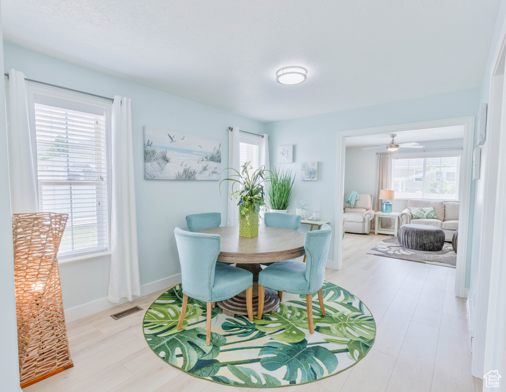 Dining room with wood finished floors, ceiling fan, and baseboards