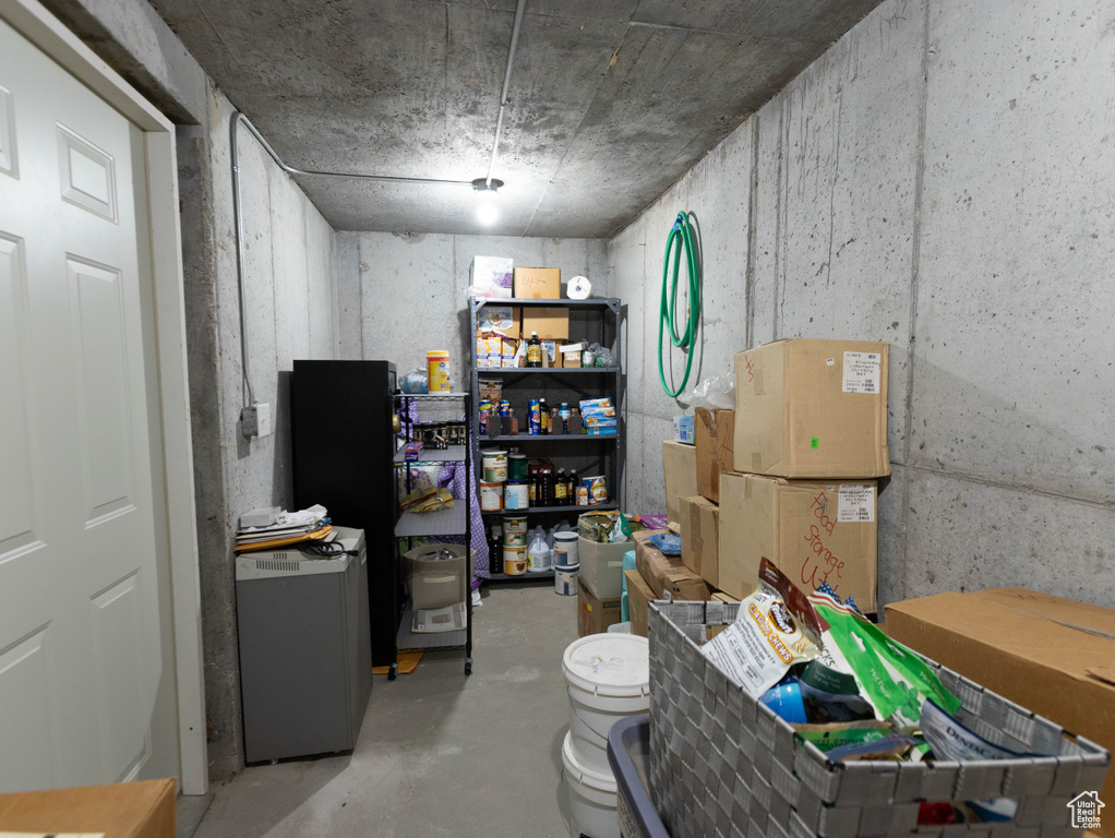 Below grade area featuring refrigerator