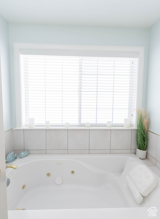 Bathroom featuring plenty of natural light and a whirlpool tub