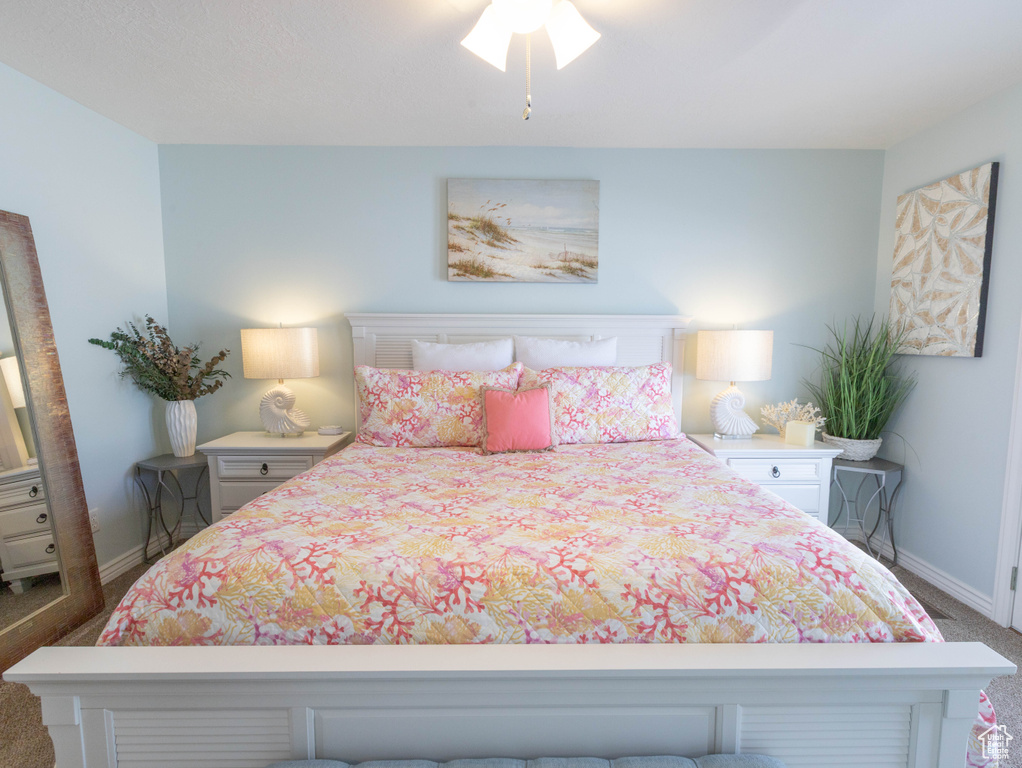 Bedroom featuring carpet floors and baseboards