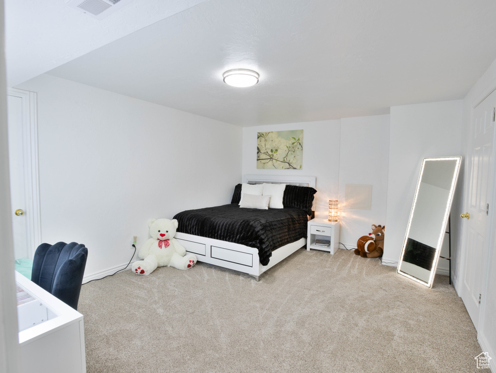 Bedroom with carpet flooring and baseboards