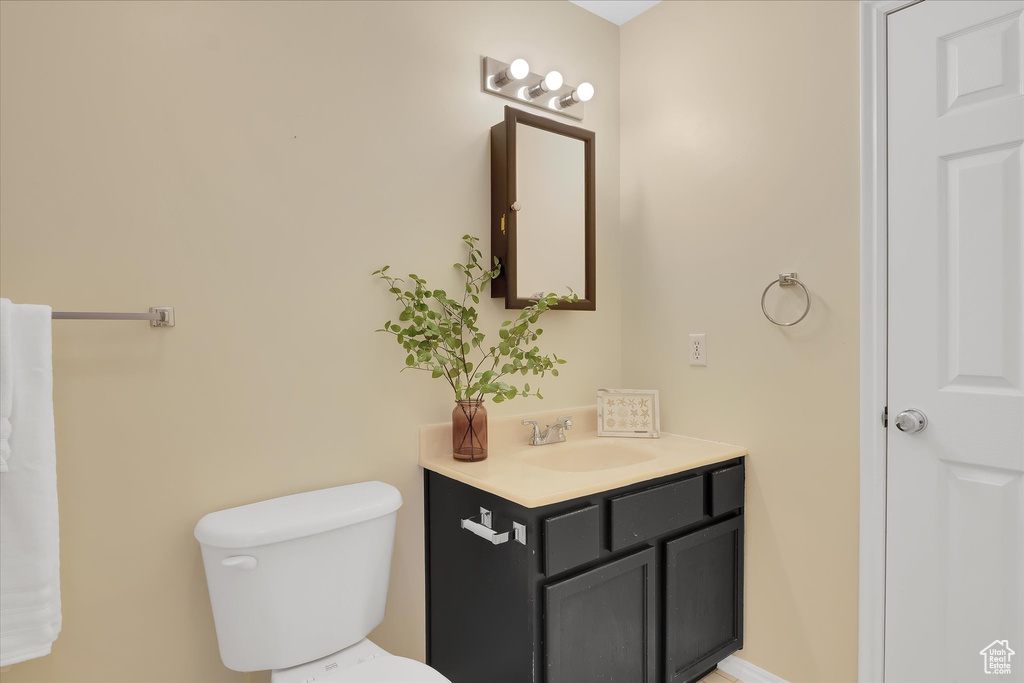 Half bath featuring vanity and toilet