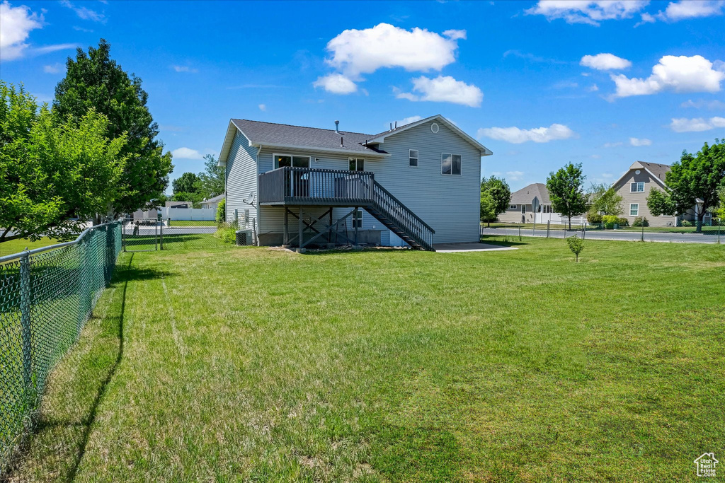 Back of house with stairs, a deck, and central air condition unit