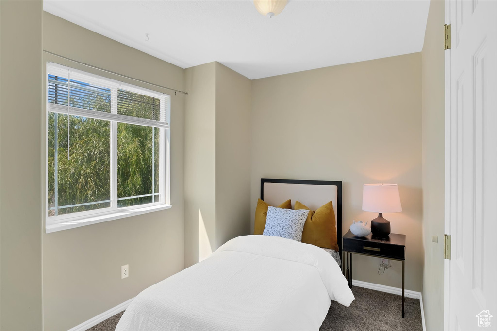 Carpeted bedroom featuring baseboards