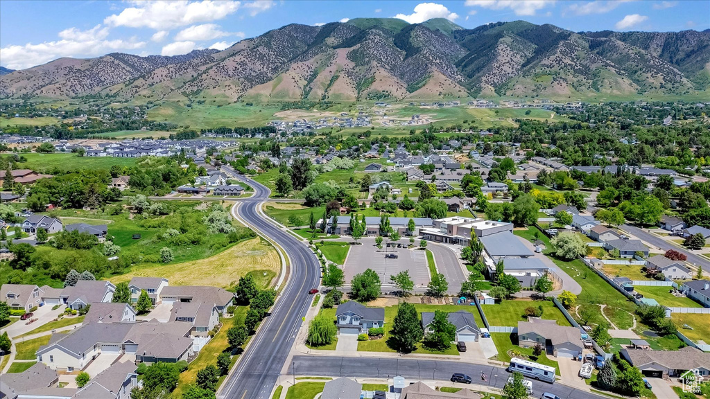 Aerial overview of property\'s location with nearby suburban area and a mountain backdrop