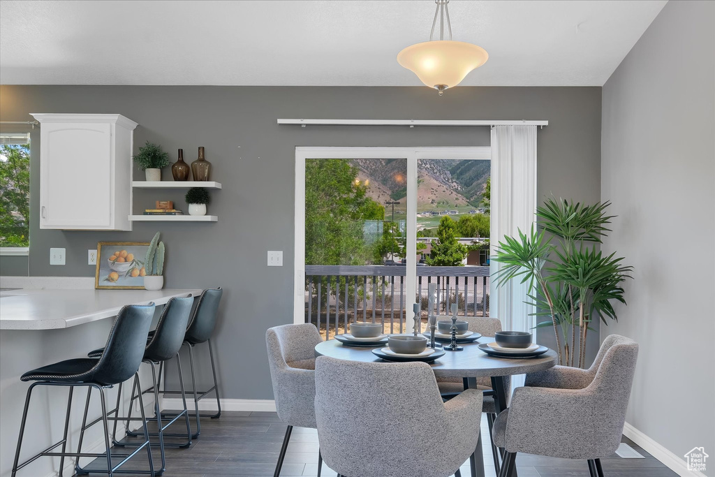Dining space with healthy amount of natural light, wood finished floors, and baseboards
