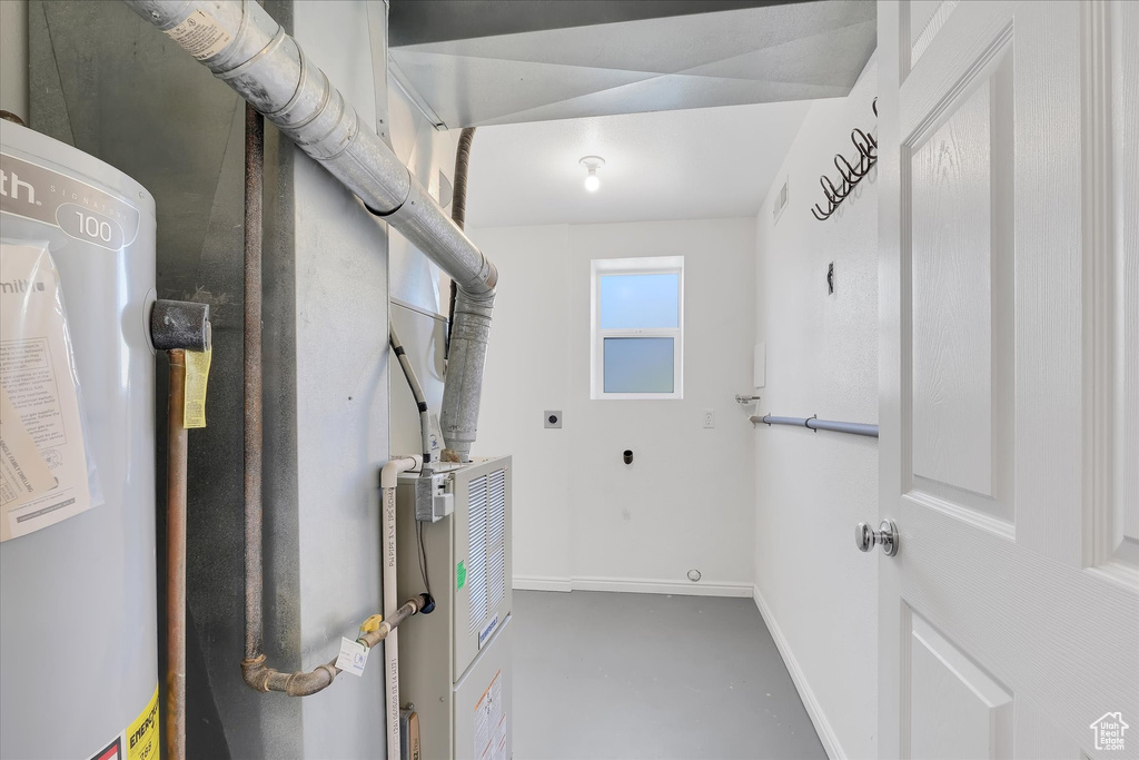 Utility room featuring gas water heater