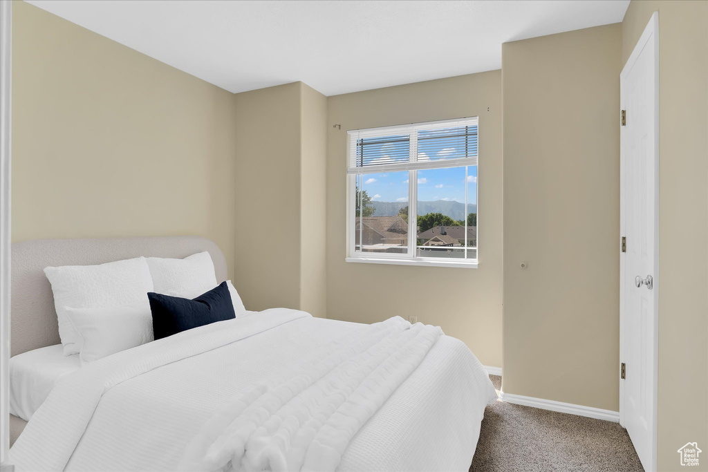 Bedroom featuring carpet flooring and baseboards
