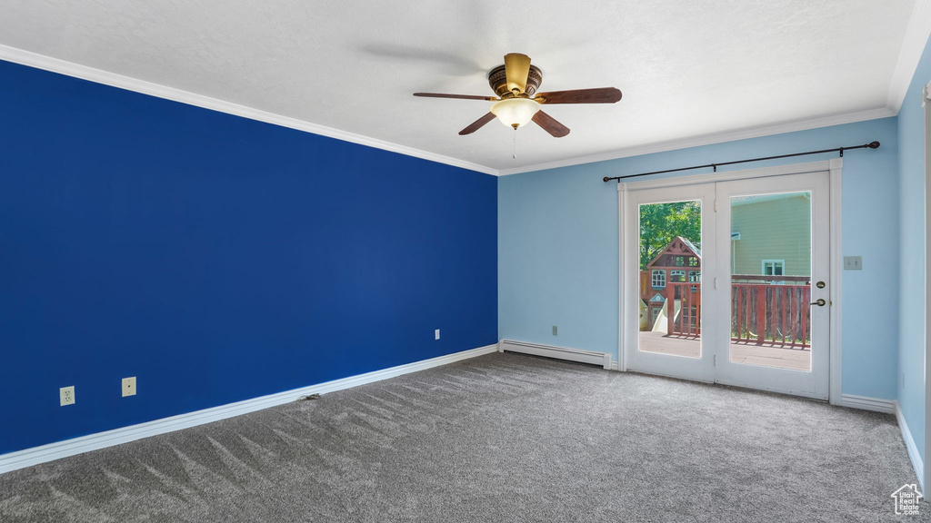 Empty room with a baseboard radiator, baseboards, carpet, ceiling fan, and crown molding