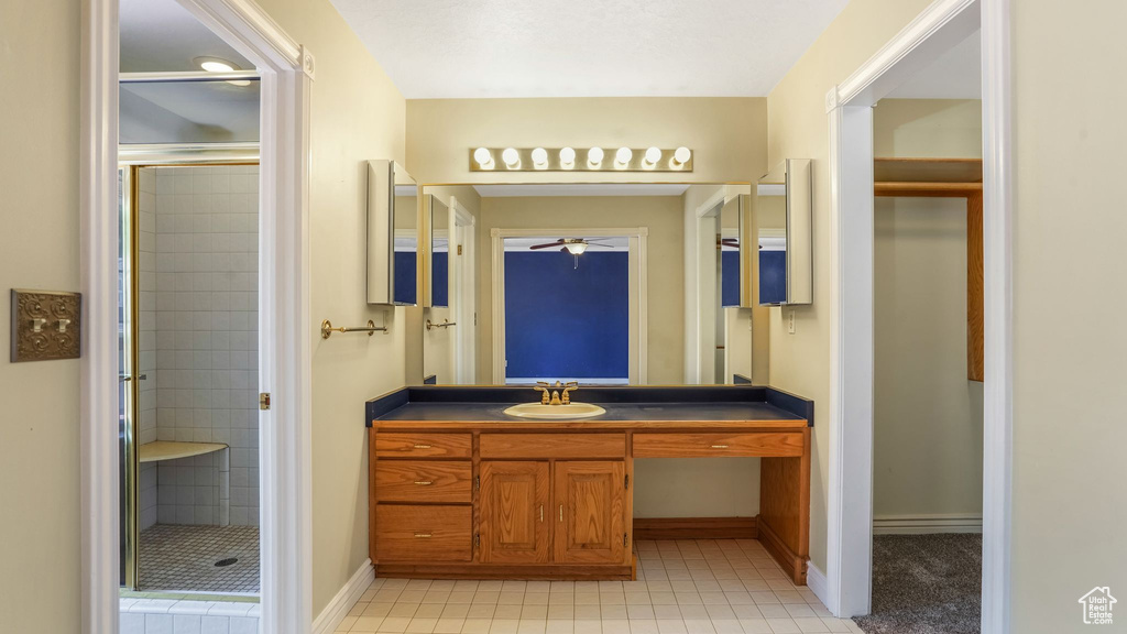 Full bath with a stall shower, a ceiling fan, vanity, and tile patterned flooring