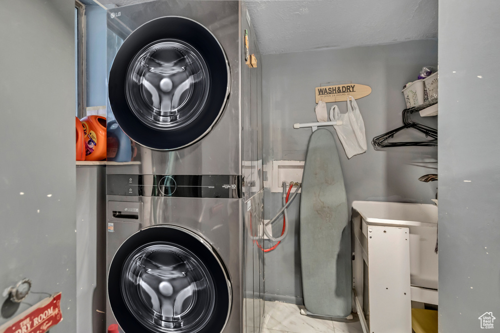 Laundry area featuring stacked washing machine and dryer