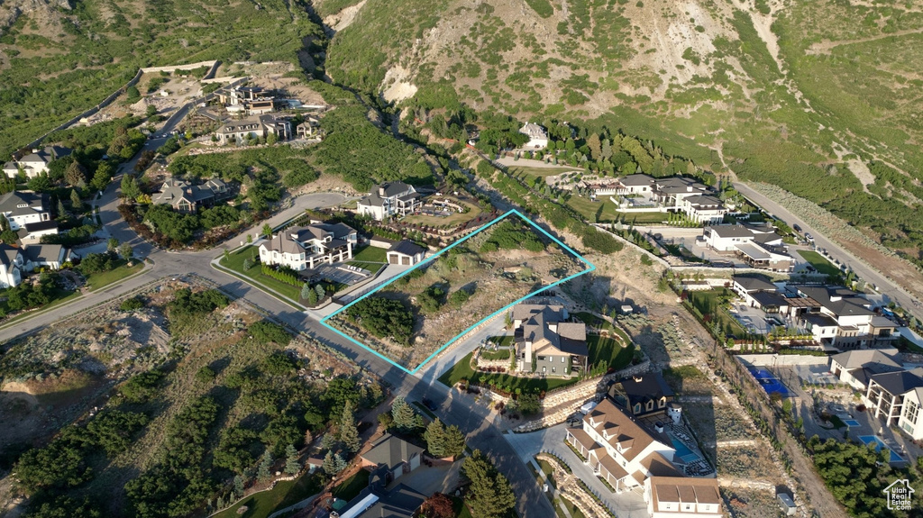 Aerial perspective of suburban area featuring property boundaries highlighted