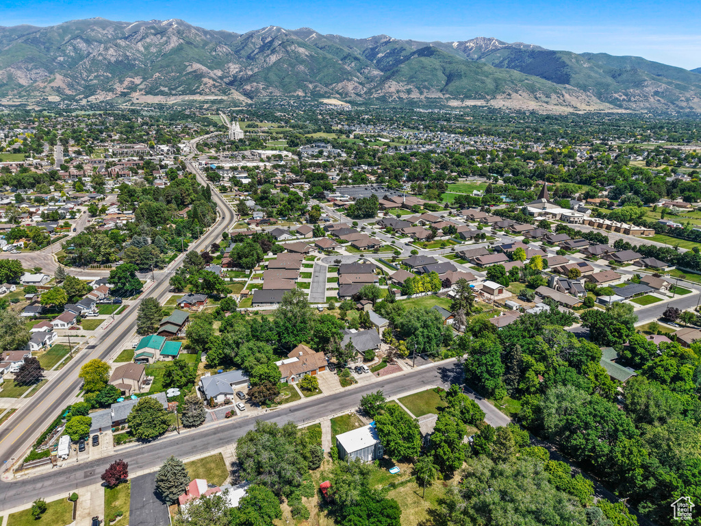 Aerial view of property\'s location featuring a mountainous background
