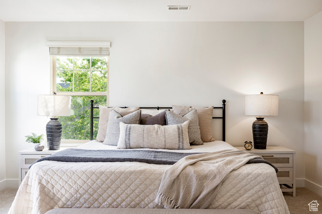 Bedroom featuring carpet and baseboards