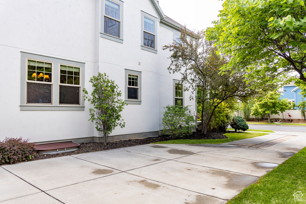 View of side of home featuring stucco siding