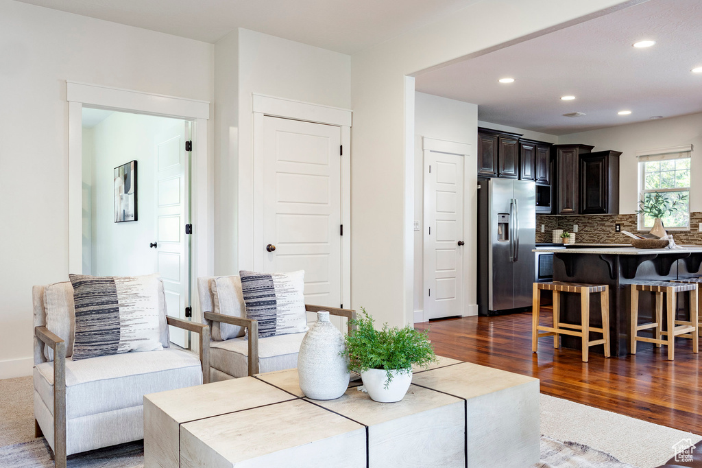 Living area with recessed lighting, dark wood-style floors, and baseboards