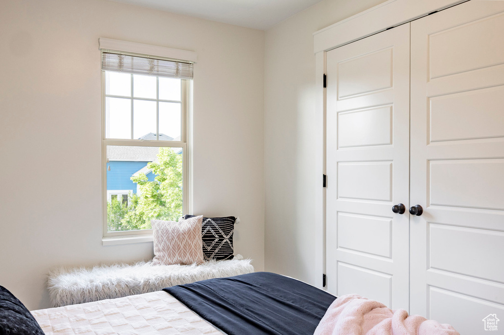 Bedroom with multiple windows and a closet