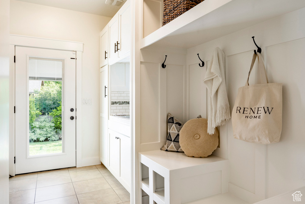 Mudroom with light tile patterned flooring