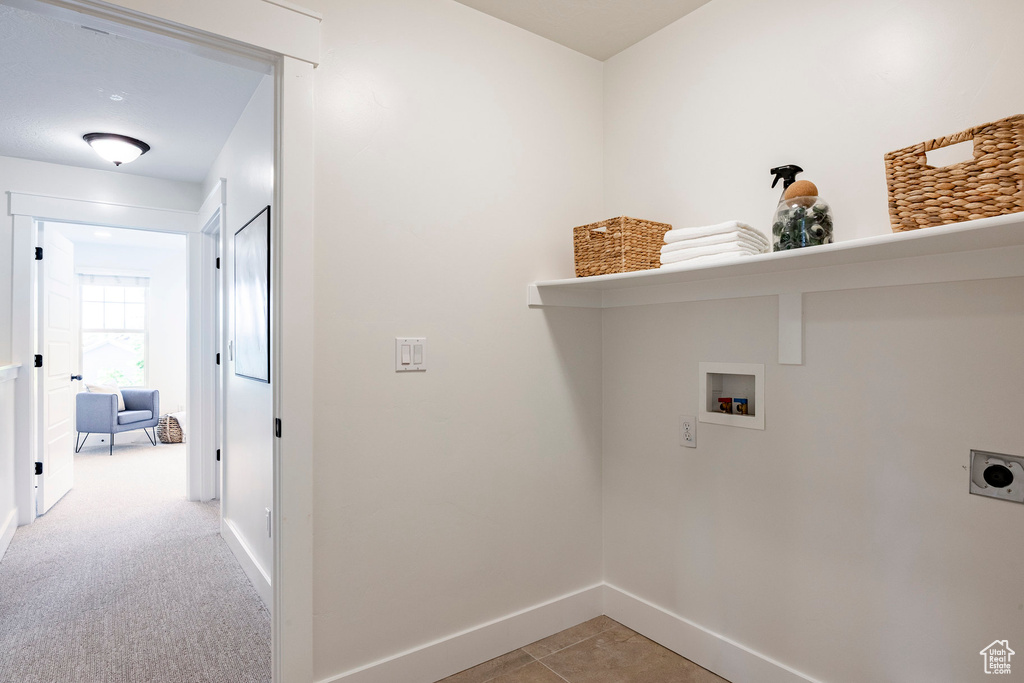 Washroom featuring washer hookup, hookup for an electric dryer, and baseboards