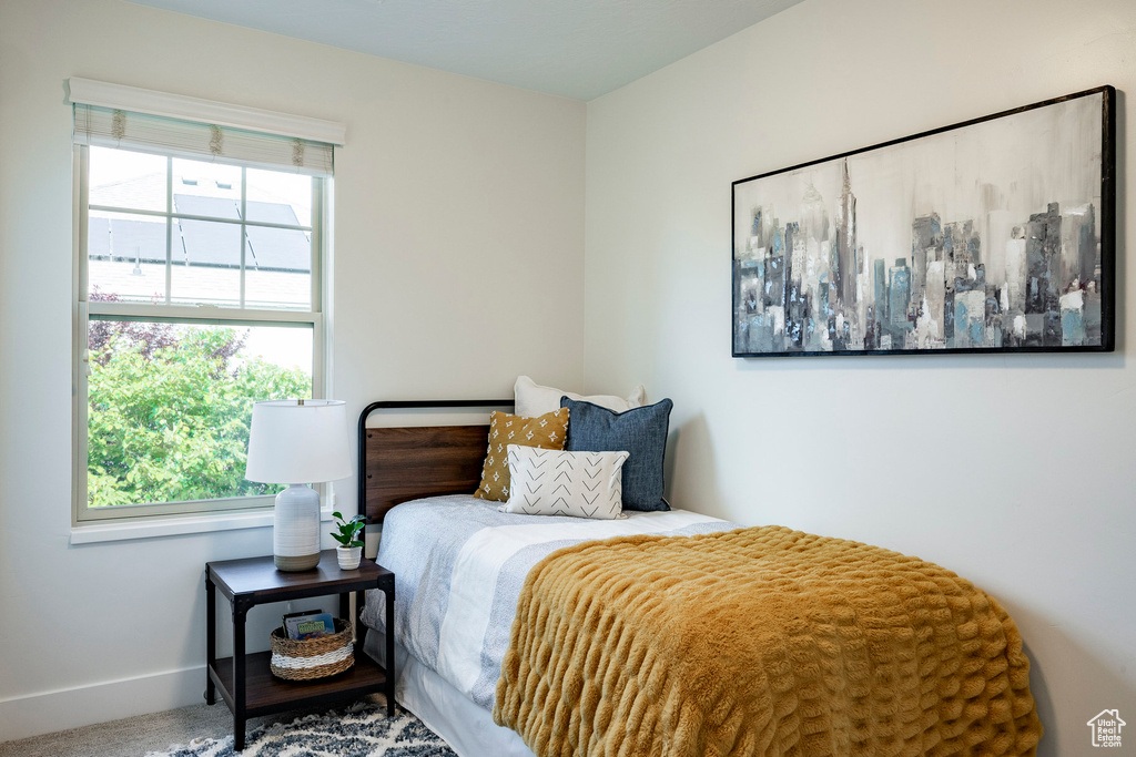Bedroom featuring multiple windows and baseboards