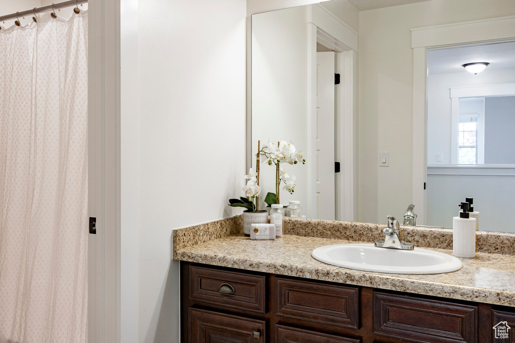 Full bath featuring vanity and curtained shower