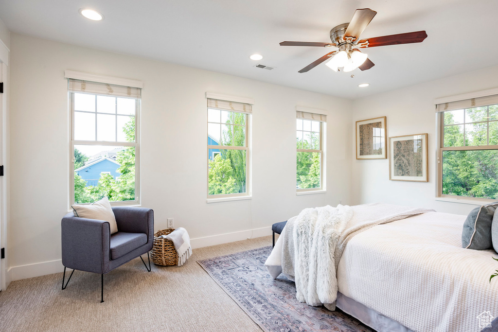Carpeted bedroom with multiple windows, recessed lighting, baseboards, and a ceiling fan