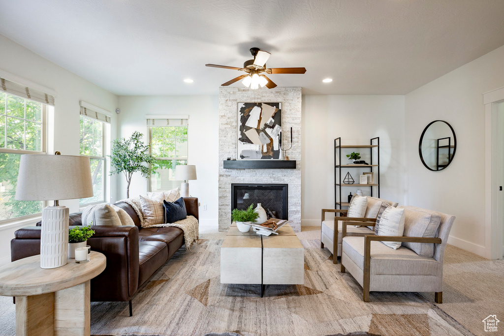 Living area featuring a ceiling fan, a fireplace, recessed lighting, and baseboards