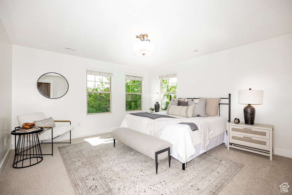 Carpeted bedroom featuring baseboards