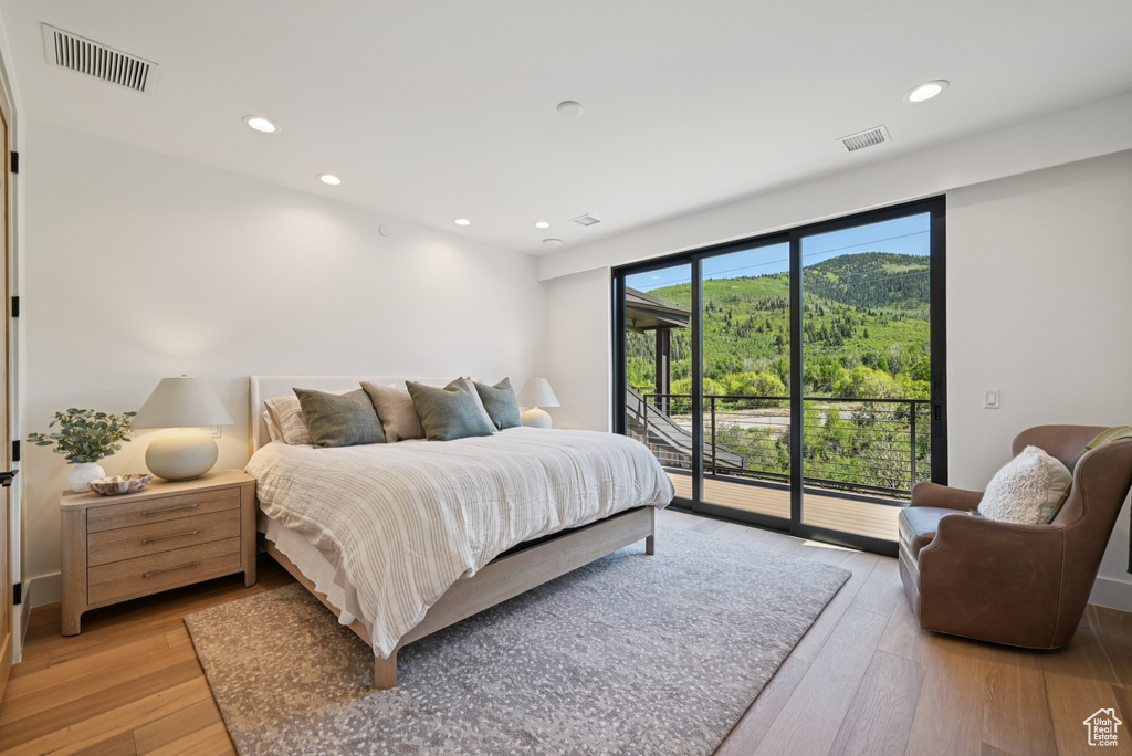 Bedroom featuring access to outside, light wood-style floors, and recessed lighting