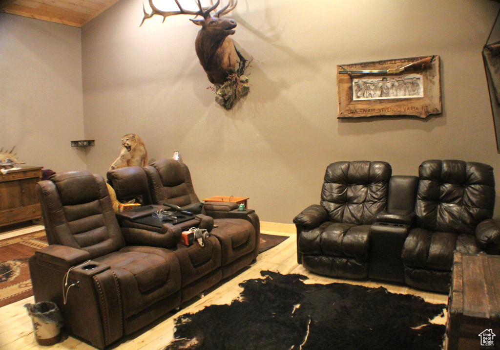 Cinema room with wood finished floors, wood ceiling, and baseboards